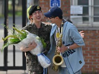 BTS star Jin celebrates in uniform after completing mandatory military service
