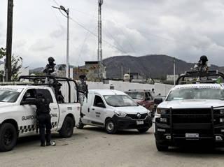 Authorities find 19 bodies piled in a dump truck in a cartel-dominated area of southern Mexico