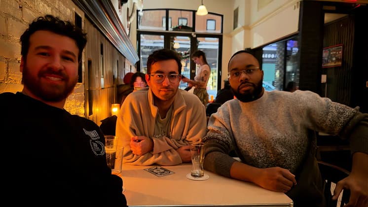 Three Ground News team members sitting together at a table