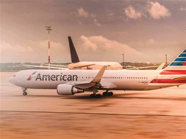 American Airlines raises bag fees, won’t allow some travel agency bookings to earn miles