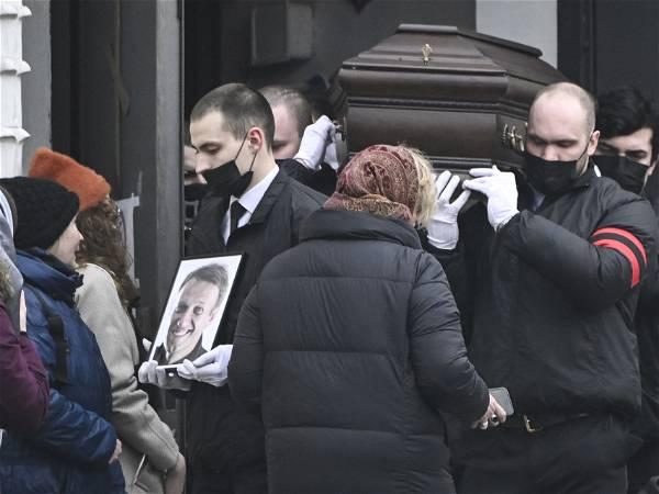 Putin foe Alexei Navalny is buried in Moscow as thousands attend under heavy police presence