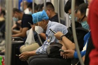 China megacity says people with symptomatic COVID can work 'as normal'